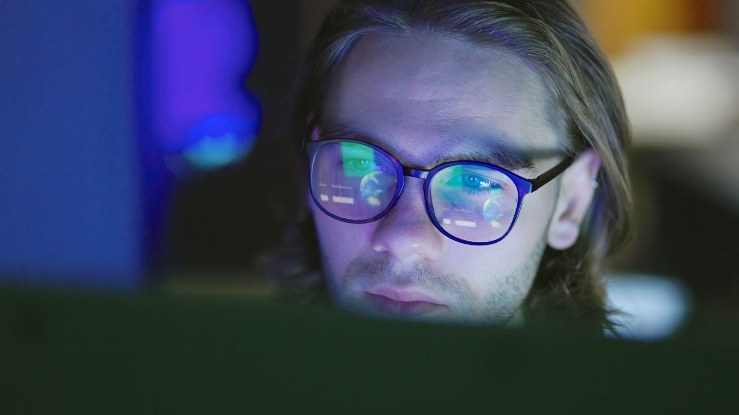 Man with Glasses reading MyAmici resources for biotech and life science organisations